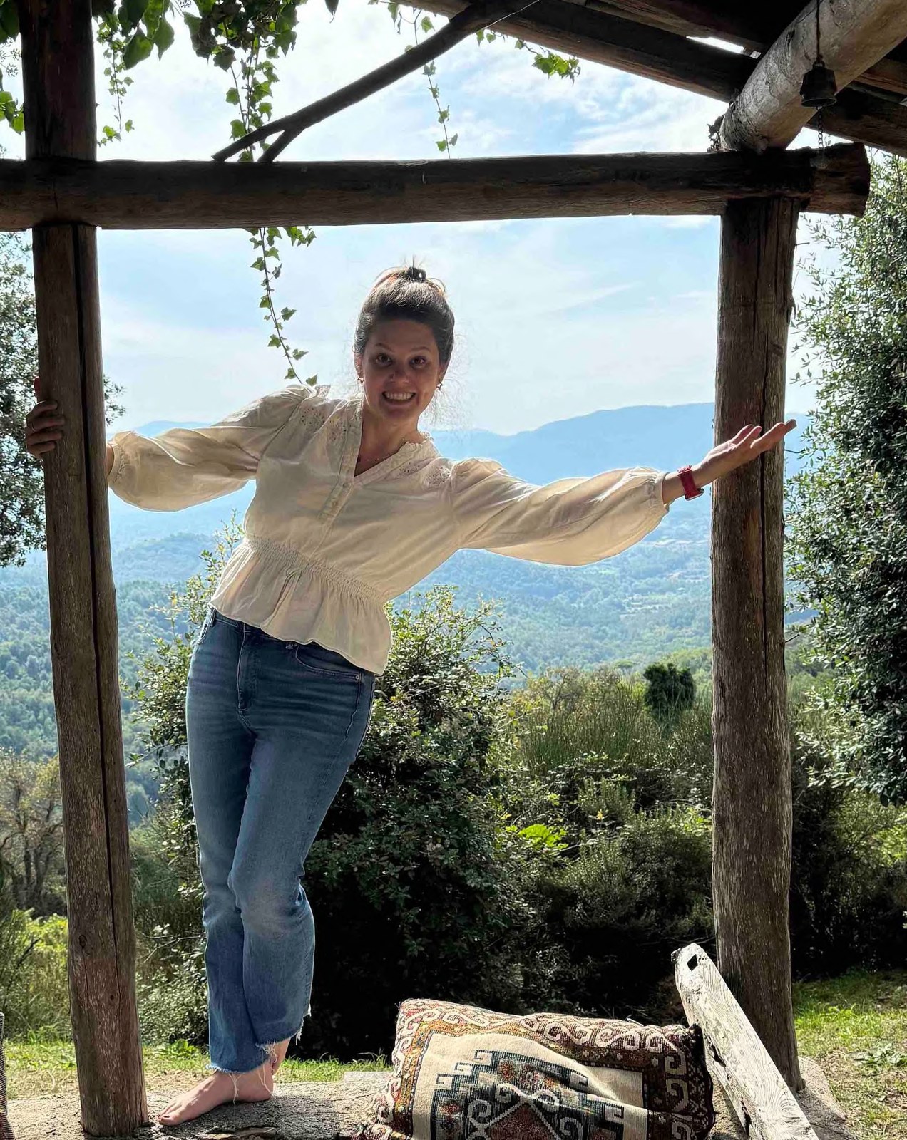Kristen outdoors with mountains and trees behind her